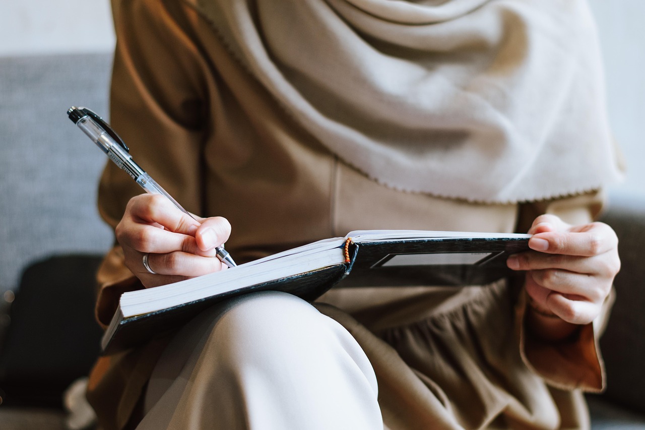 Muslim, woman, writing — Save on Replacement Costs with Expert Refrigerator Repair Mira Mesa Services